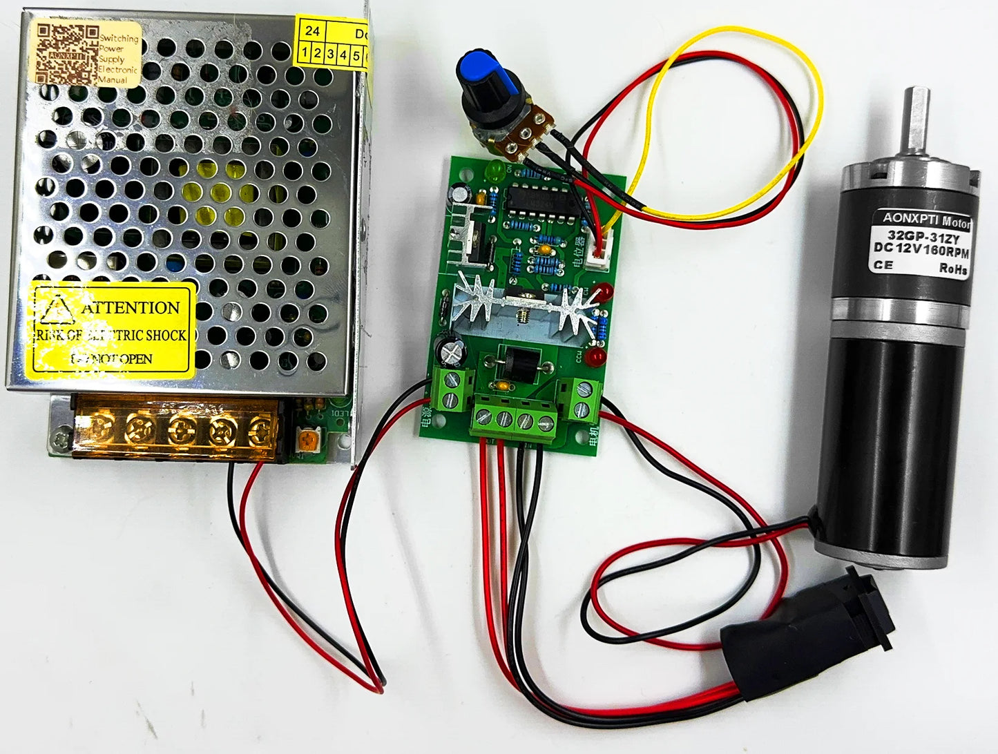 Electrical components including a power supply, circuit board, and motor on a white background